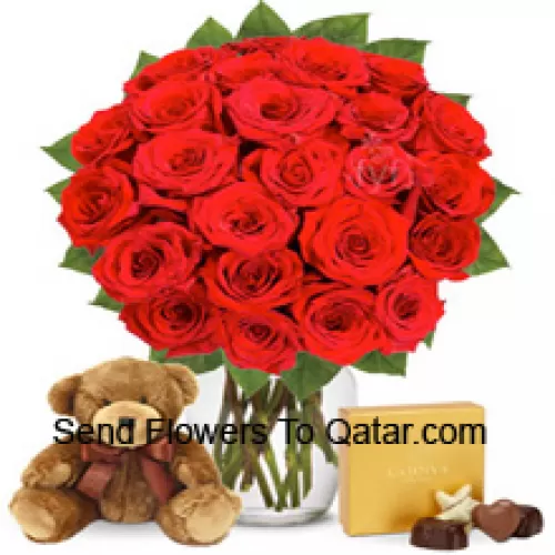 24 Red Roses With Some Ferns In A Glass Vase Accompanied With An Imported Box Of Chocolates And A Cute 12 Inches Tall Brown Teddy Bear