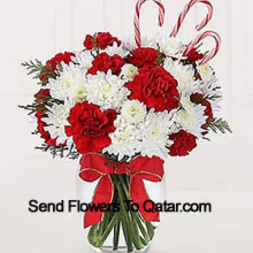 Sweeten their Christmas with a bounty of blooms and festive candy canes! A darling bouquet of red carnations and white chrysanthemums are accented with peppermint candy canes for a holiday presentation that is sure to make their holiday warm and bright. A memorable way to be a part of their holiday festivities! (Please Note That We Reserve The Right To Substitute Any Product With A Suitable Product Of Equal Value In Case Of Non-Availability Of A Certain Product)